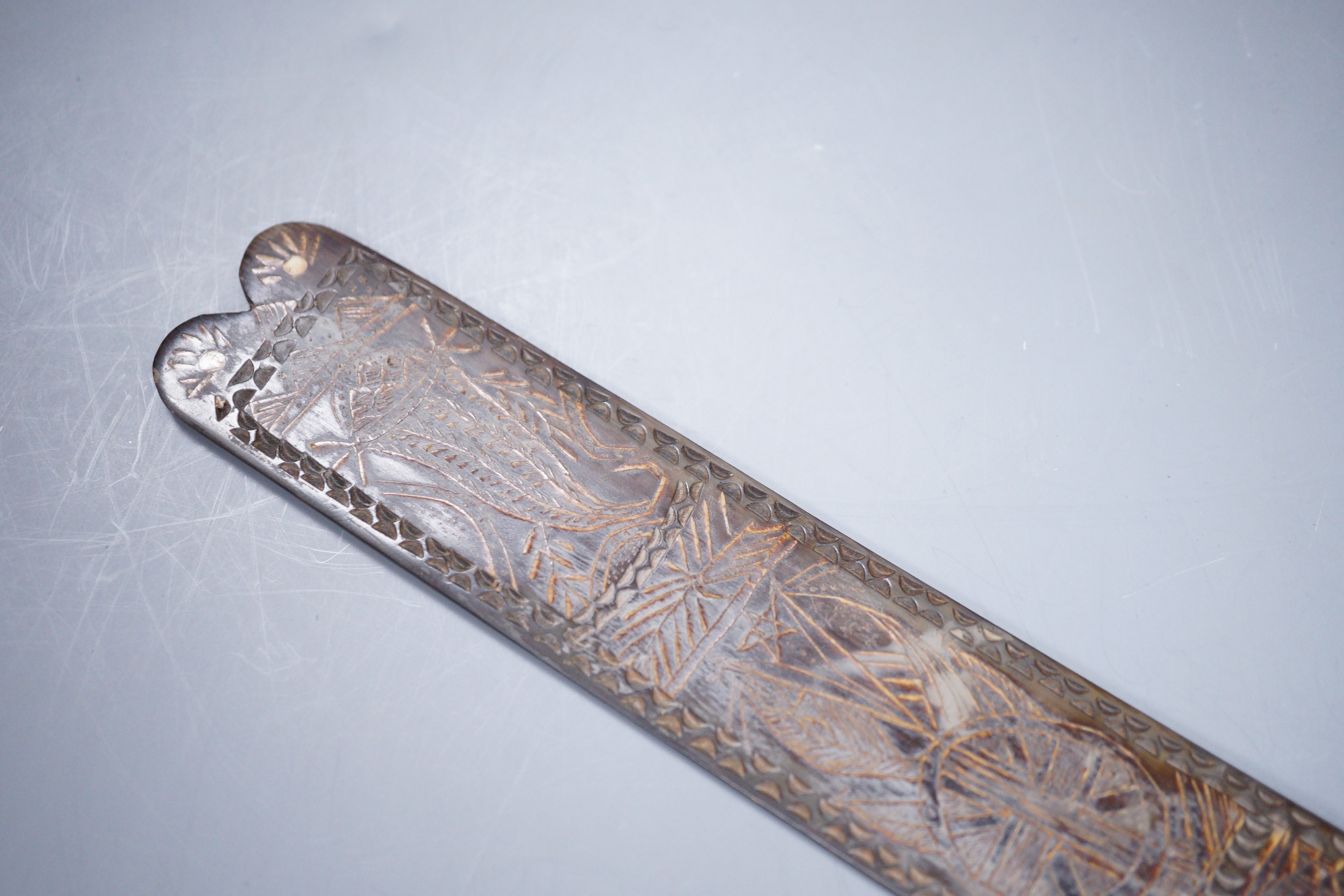 A 19th century carved horn page turner with bone inset roundels, 30.5cm